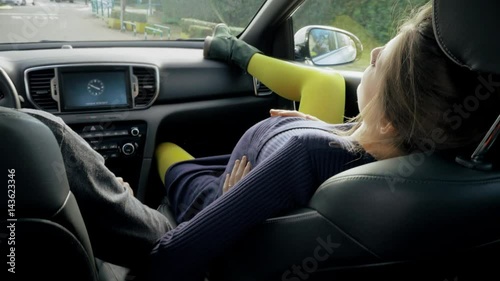 Pregnant woman with contractions telling husband to drive faster with car