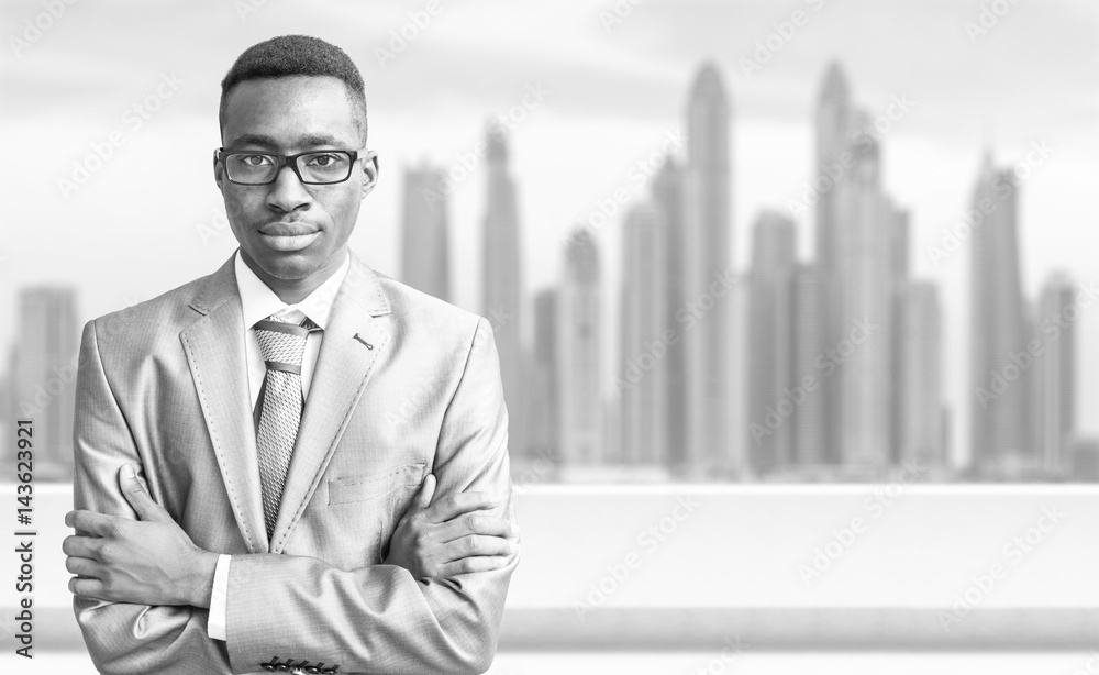 Fototapeta premium Young black businessman in front of the big city