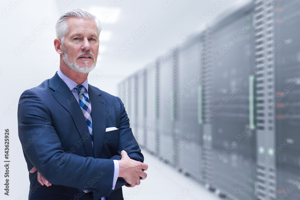 Senior businessman in server room Senior businessman in server room