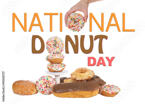 Variety of Donuts isolated on white background, National Donut Day in June and November. Hand holding donut for O in National and stacked donut for O in Donut.