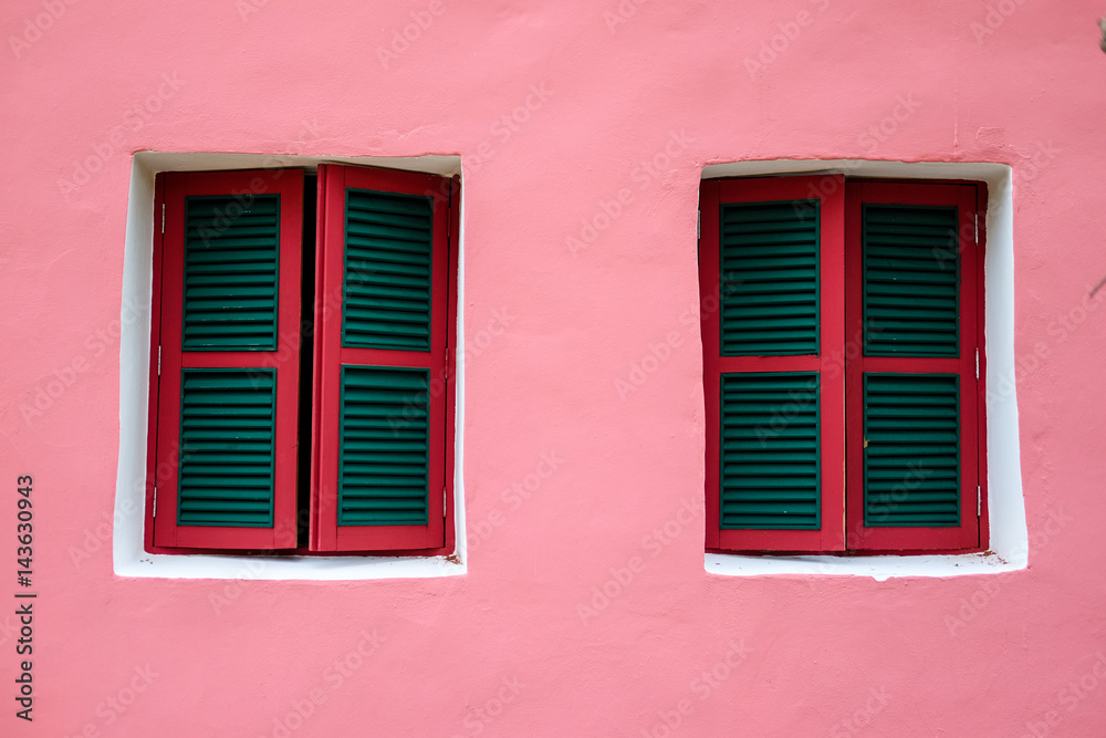 Two windows on pink wall