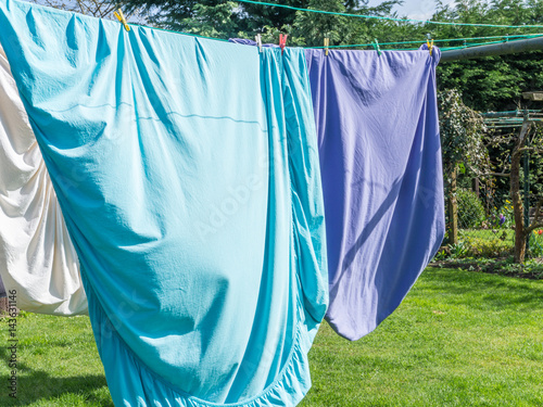 Colored laundry drying on a laundry line outside photo
