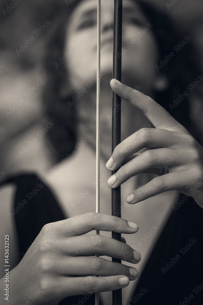 beautiful young woman holding fiddlestick