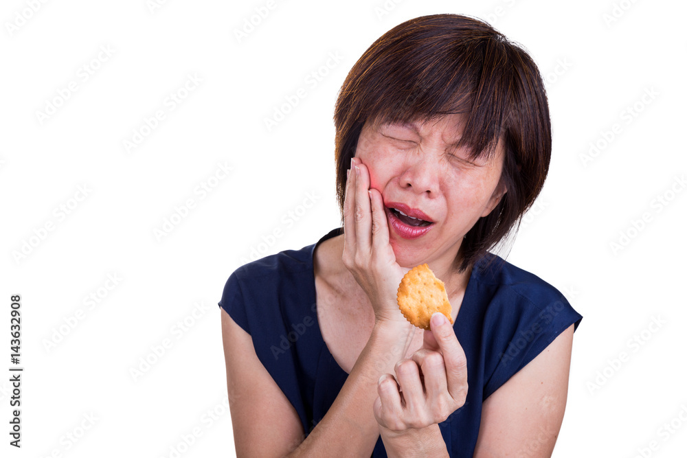 Asian women with intense toothache pain after biting cookie Asian women with intense toothache pain after biting cookie