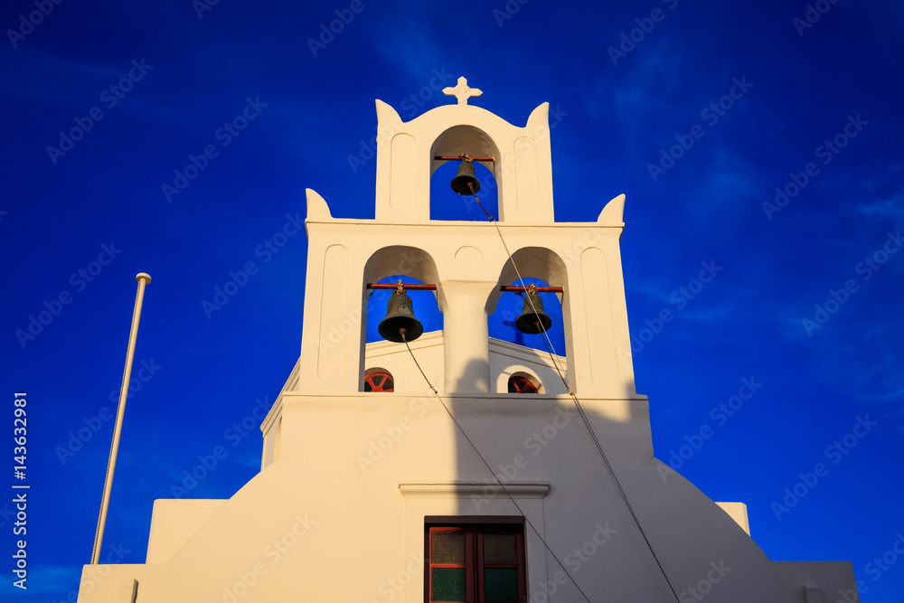 White church and bell tower in Santorini, Greece