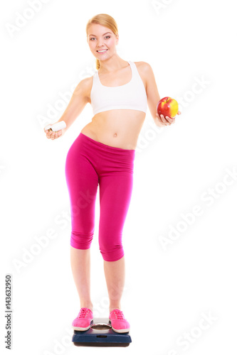 Woman holding vitamins and apple. Health care.