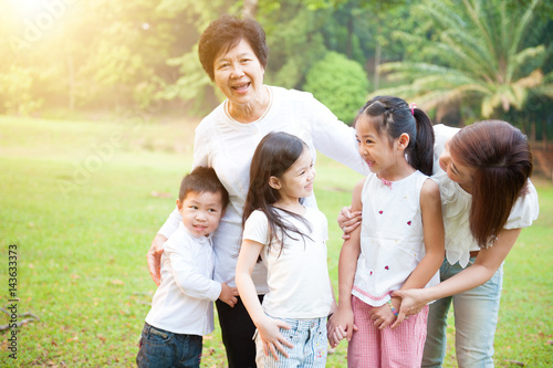 Grandmother, mother and grandchildren having fun at outdoor. © WONG SZE FEI