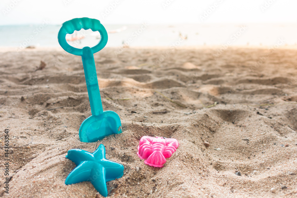 Little boy drawing sand by hand heart shape