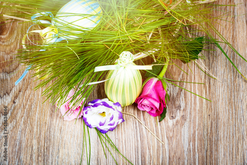 Easter eggs with flowers on wooden background. Toned image Easter eggs with flowers on wooden background. Toned image