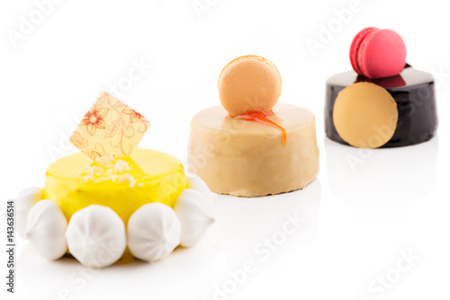 Three sweet and tasty cakes on the white background.