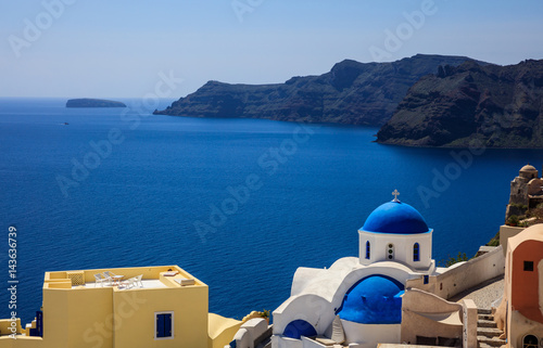 White church with blue dome in Santorini, Greece