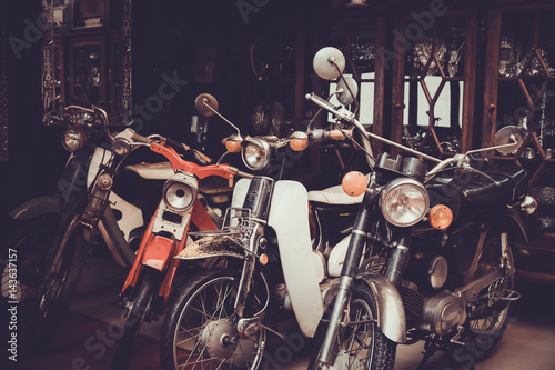 Old and Classic motorcycle parked in garage. Vintage color tone effect.