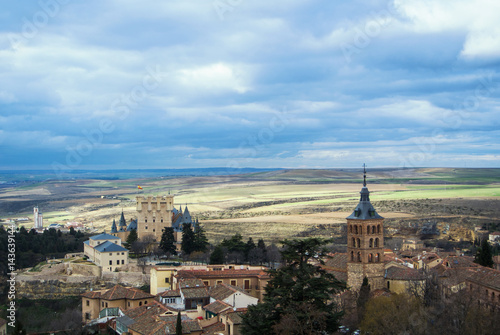 Castle of Segovia, a tower and old medieval buildings with fields at the baackground, a view from an observation deck at Cathedral of the city, Castilla and Leon, Spain. © Victoria