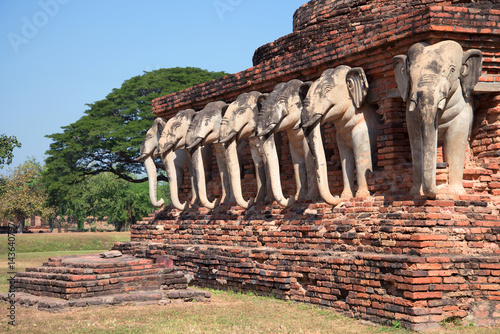 Sculptures of elephants on the base of the stupa of buddhist temple of Wat Sorasak. Sukhothai, Thailand photo