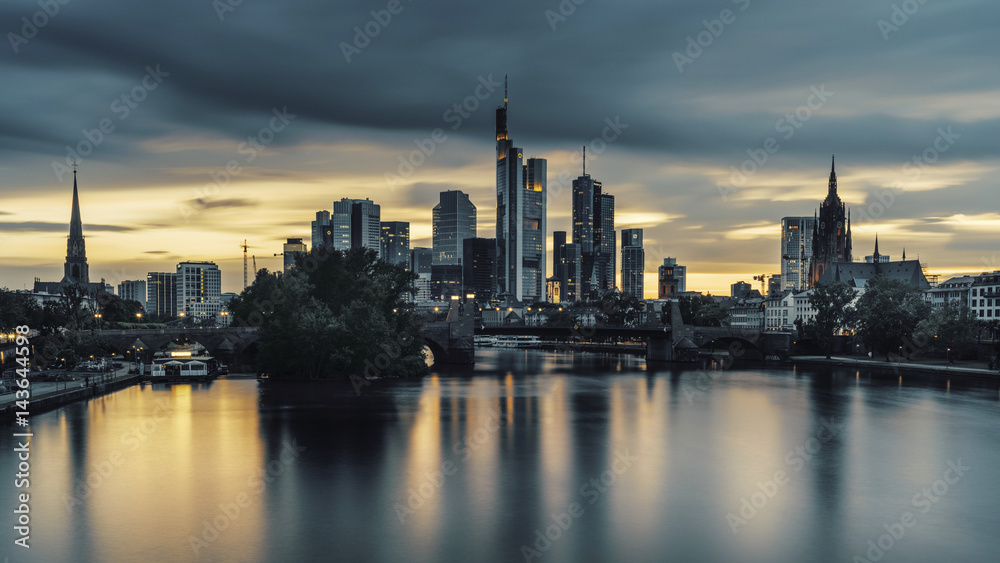 Frankfurt skyline at dusk under stormy skies