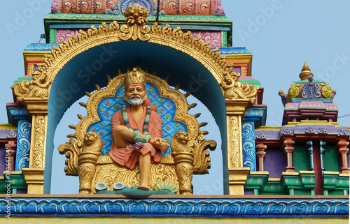 Idol of shirdi Sai Baba in sitting posture on the arch of temple