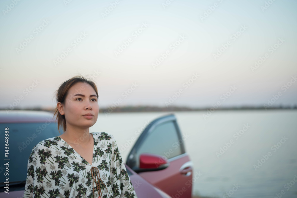 young woman sad and car at roadside and sunset time