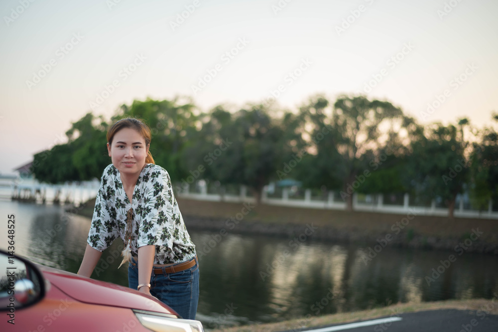 young woman happy and car red