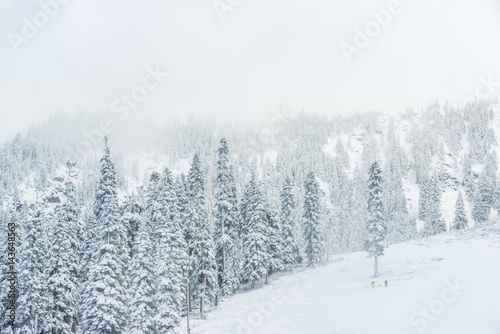 scenic view of small people walking in snow mountain.