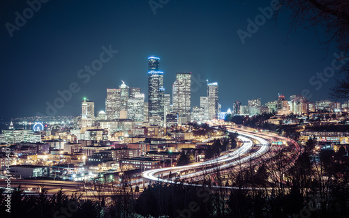 Seattle cityscape at night with traffic light on freeway Washington usa.