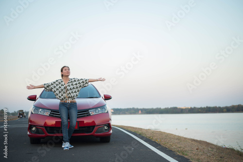 young woman happy and car red