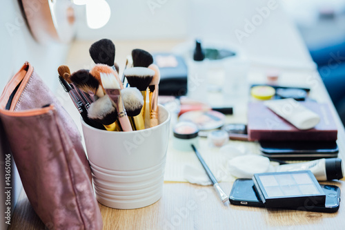 Make up table in beauty salon. Real working environment. Set of professional brushes for makeup. Make up beauty salon equipment for visage.