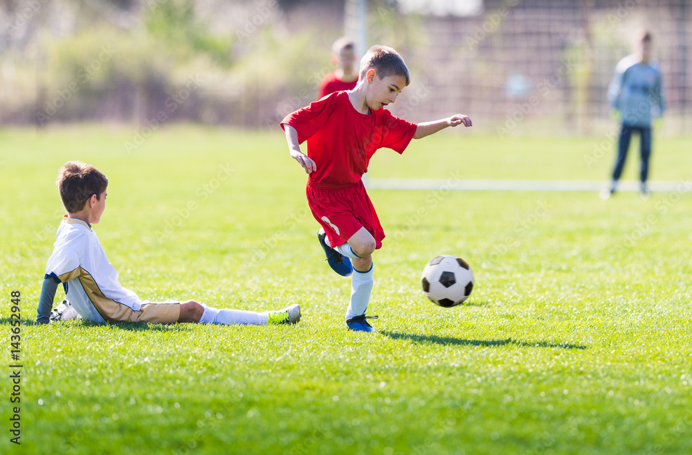 Obraz premium Kids soccer football - children players match on soccer field