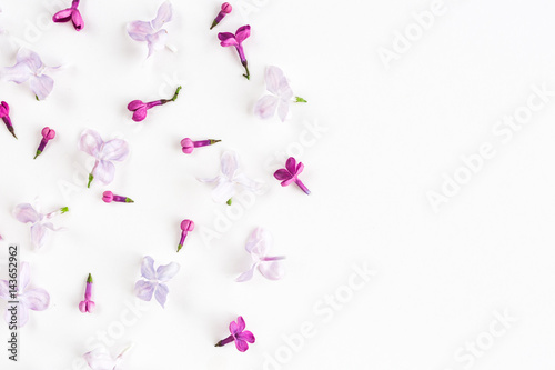 white background on a half filled with lilac flowers. Concept of freshness and beautifulness. Flat lay. Top view. Empty space for the text. © melnikofd