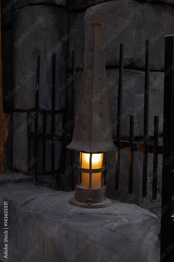 Naklejka premium Mystical image of an old lantern at a wooden wall.