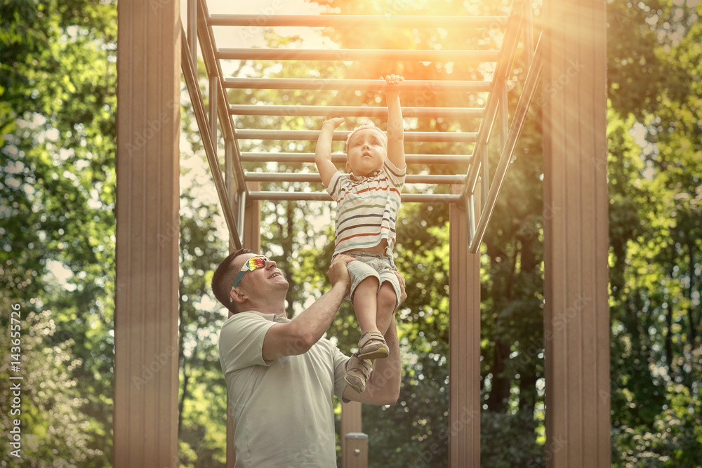 Father and son exercising outdoor. Father and son exercising outdoor.