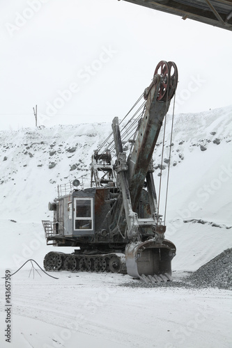 Big Excavator to load crushed iron ore, crushed stone, rocks. (in the winter)