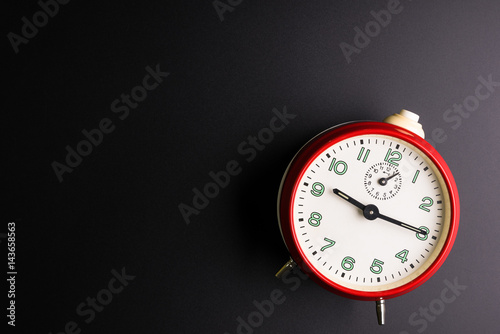 Red alarm clock isolated on black background, Time concept, Rush hour concept, Copy space image for your text, Flat lay.