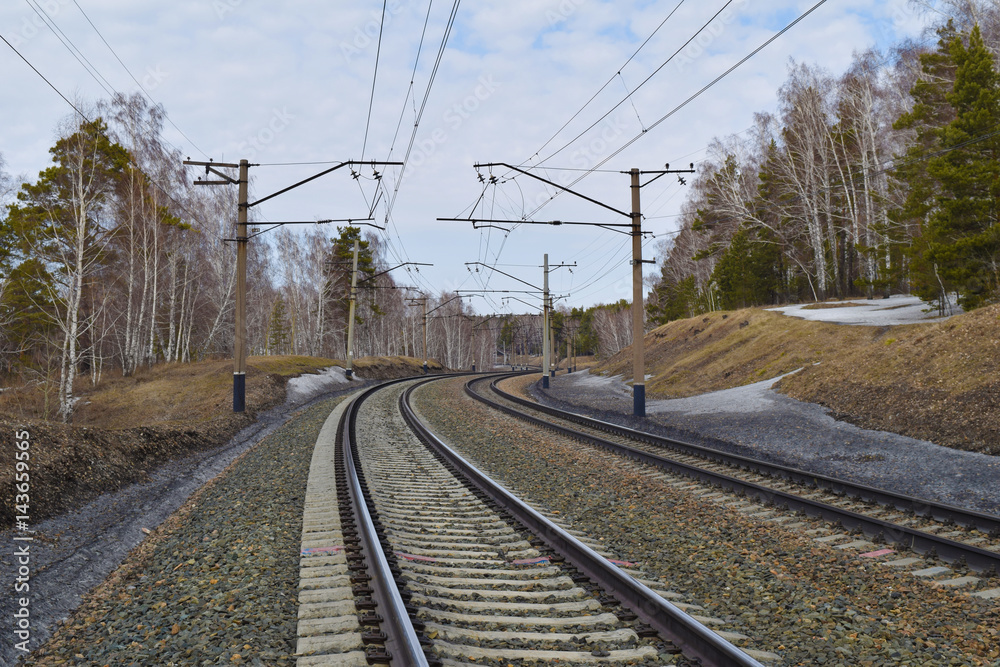 Trans-siberian railway in Siberian taiga forest in spring. Novosibirsk, Siberia, Russia.