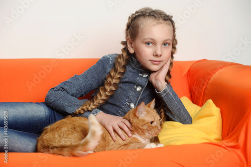 Girl with a red cat at home