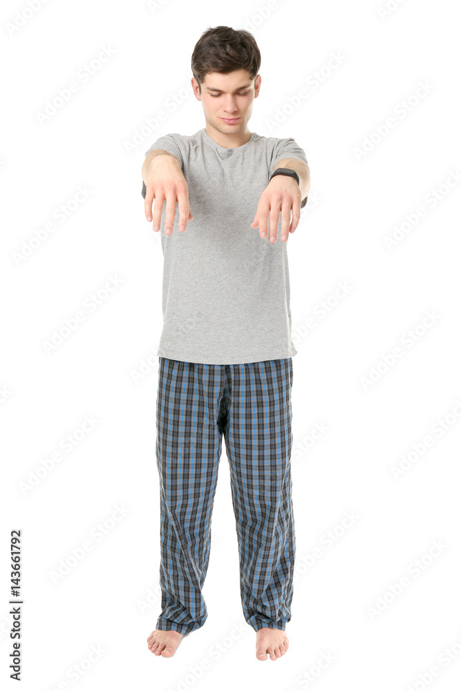 Young sleepy man suffering from somnambulism on white background Young sleepy man suffering from somnambulism on white background