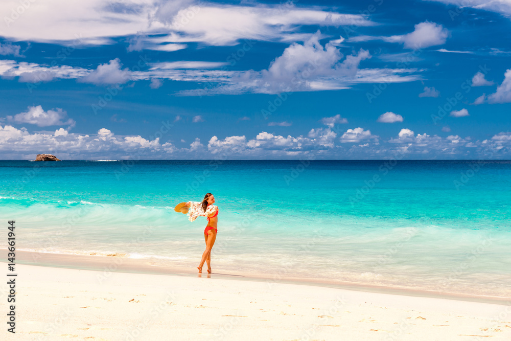Woman with sarong on beach at Seychelles