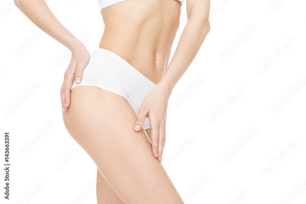 Great shape. Cropped studio shot of a fit female model showing off her flat stomach posing touching her upper leg isolated on white copyspace on the side.