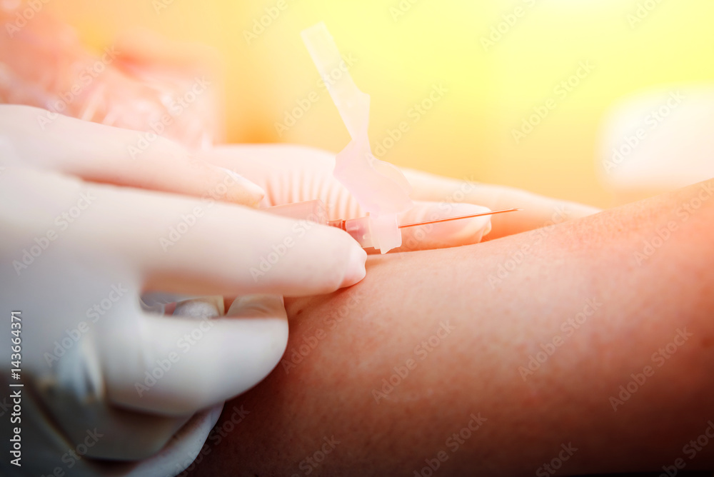 Naklejka premium Closeup of nurse's hands taking a blood sample