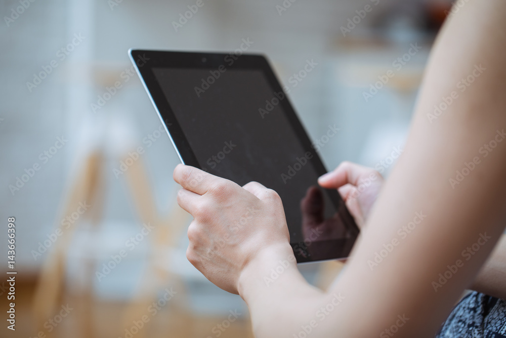Close-up of digital tablet in a young womans hands