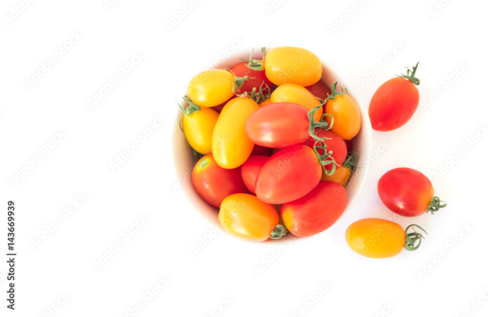 Top view fresh cherry tomatoes in bowl on white background Top view fresh cherry tomatoes in bowl on white background
