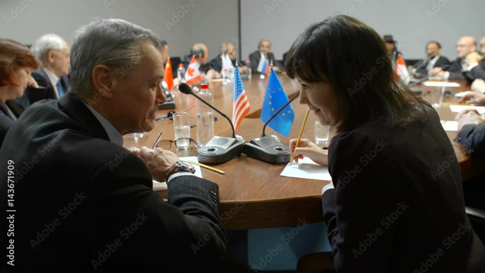Private discussion of two professional politicians at international business forum, conference or summit. Delegates of US and Germany talk about partnership and relations