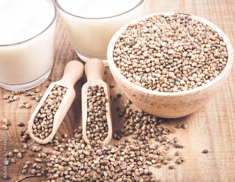 Hemp milk, seeds on wooden background . Close Up . Hemp milk, seeds on wooden background . Close Up .