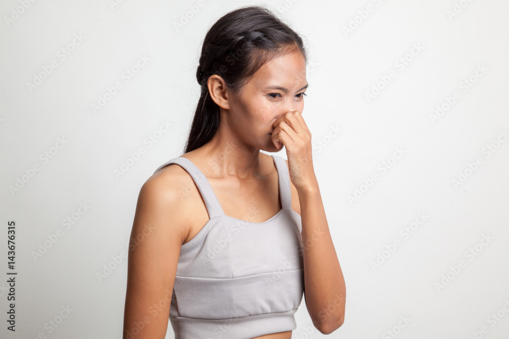 Young Asian woman holding her nose because of a bad smell. Young Asian woman holding her nose because of a bad smell.