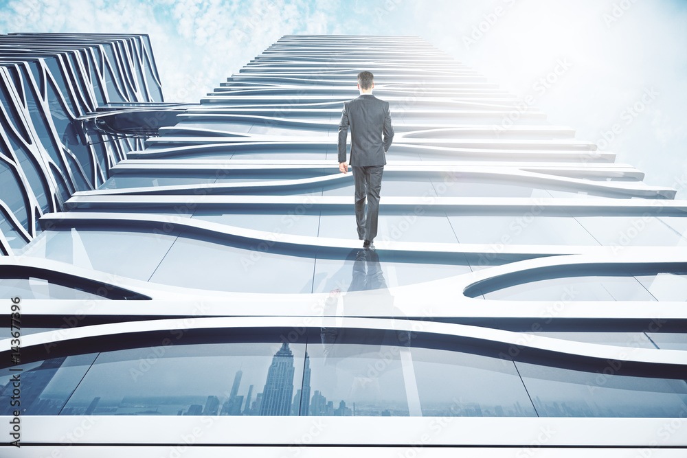 Businessman walking up glass building Businessman walking up glass building