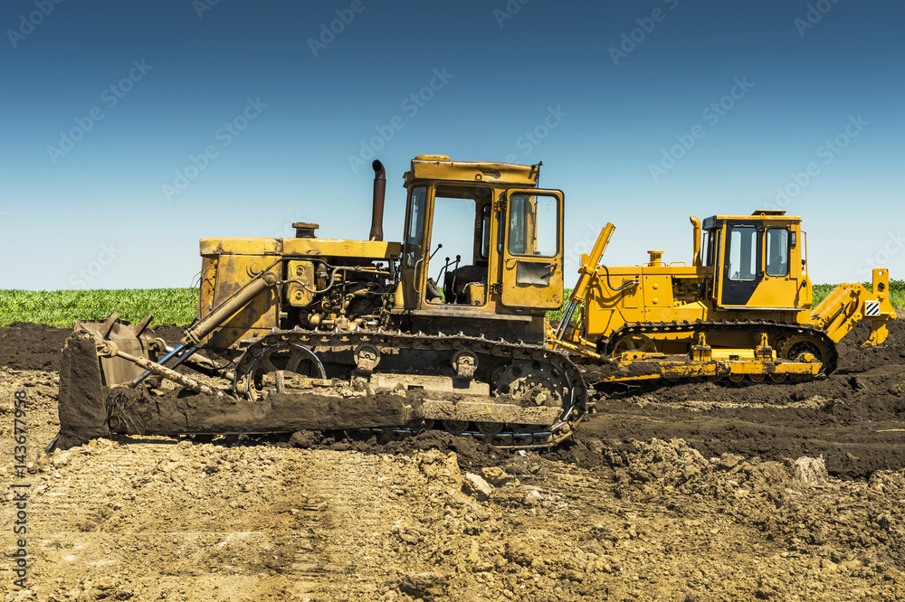 yellow bulldozer on a sunny day in the field