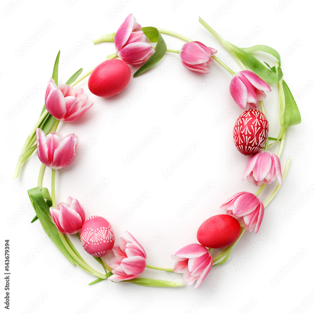 Easter eggs and tulips on white background. Flat lay. Top view