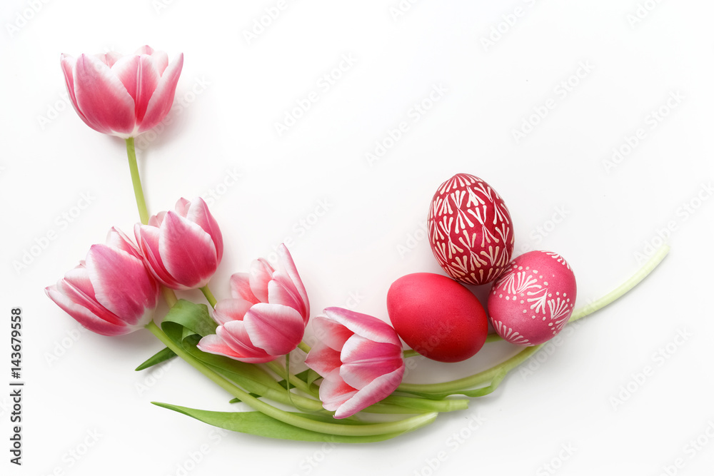 Easter eggs and tulips on white background. Flat lay. Top view Easter eggs and tulips on white background. Flat lay. Top view
