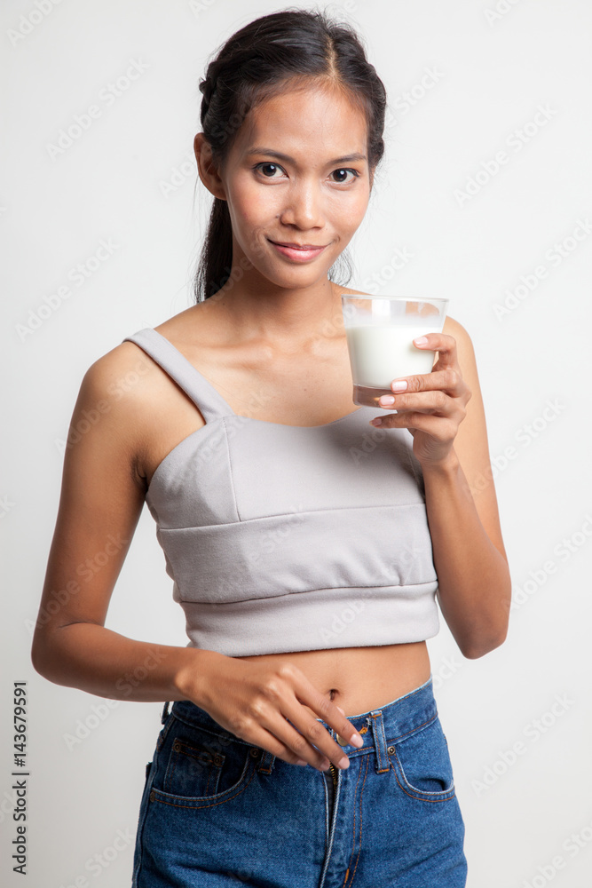 Healthy Asian woman drinking a glass of milk. Healthy Asian woman drinking a glass of milk.