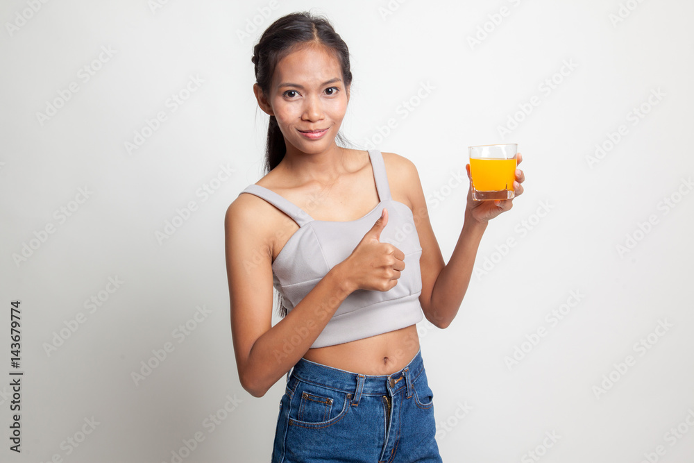 Young Asian woman thumbs up drink orange juice. Young Asian woman thumbs up drink orange juice.