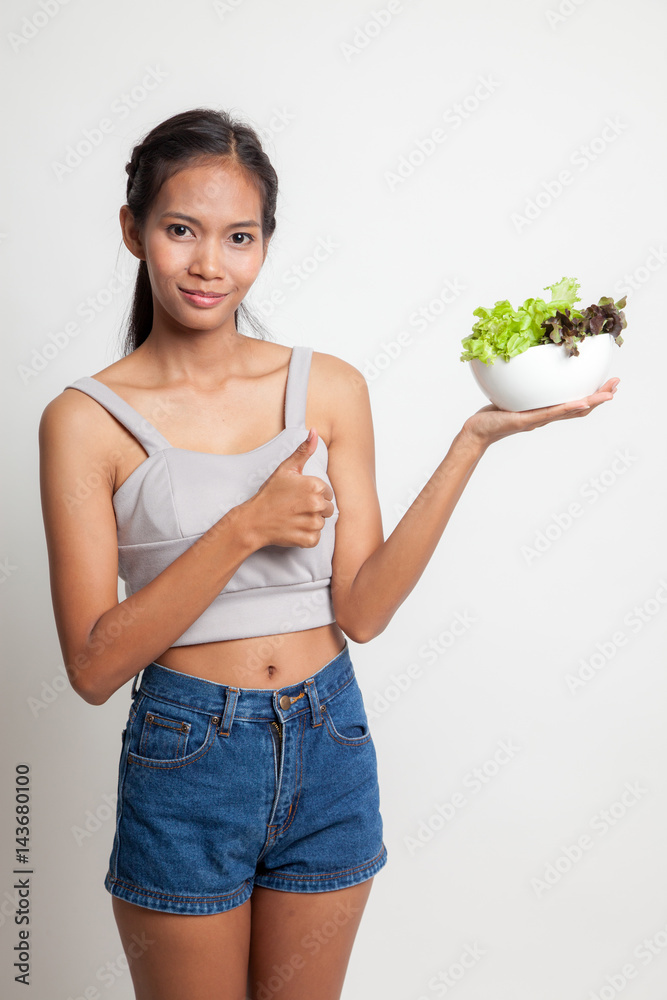 Healthy Asian woman thumbs up with salad. Healthy Asian woman thumbs up with salad.